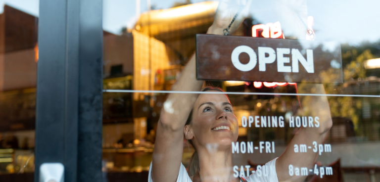 Woman hanging Open sign