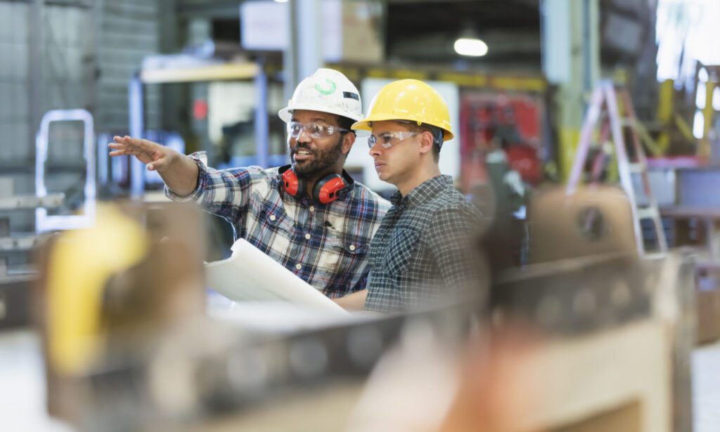 Manager instructing member of his team