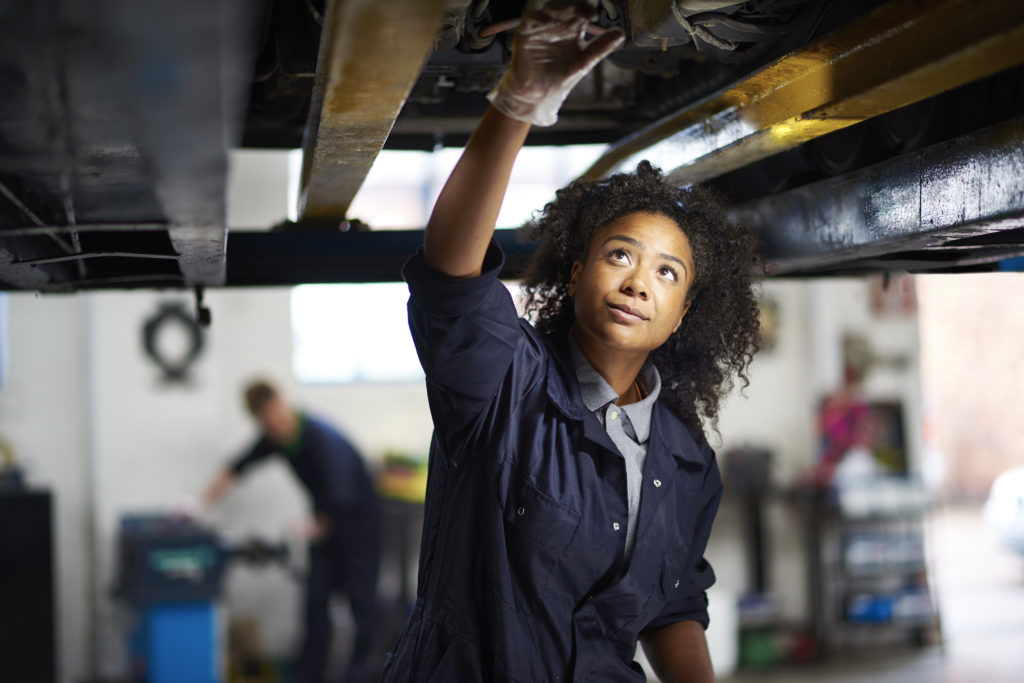 Woman working on car