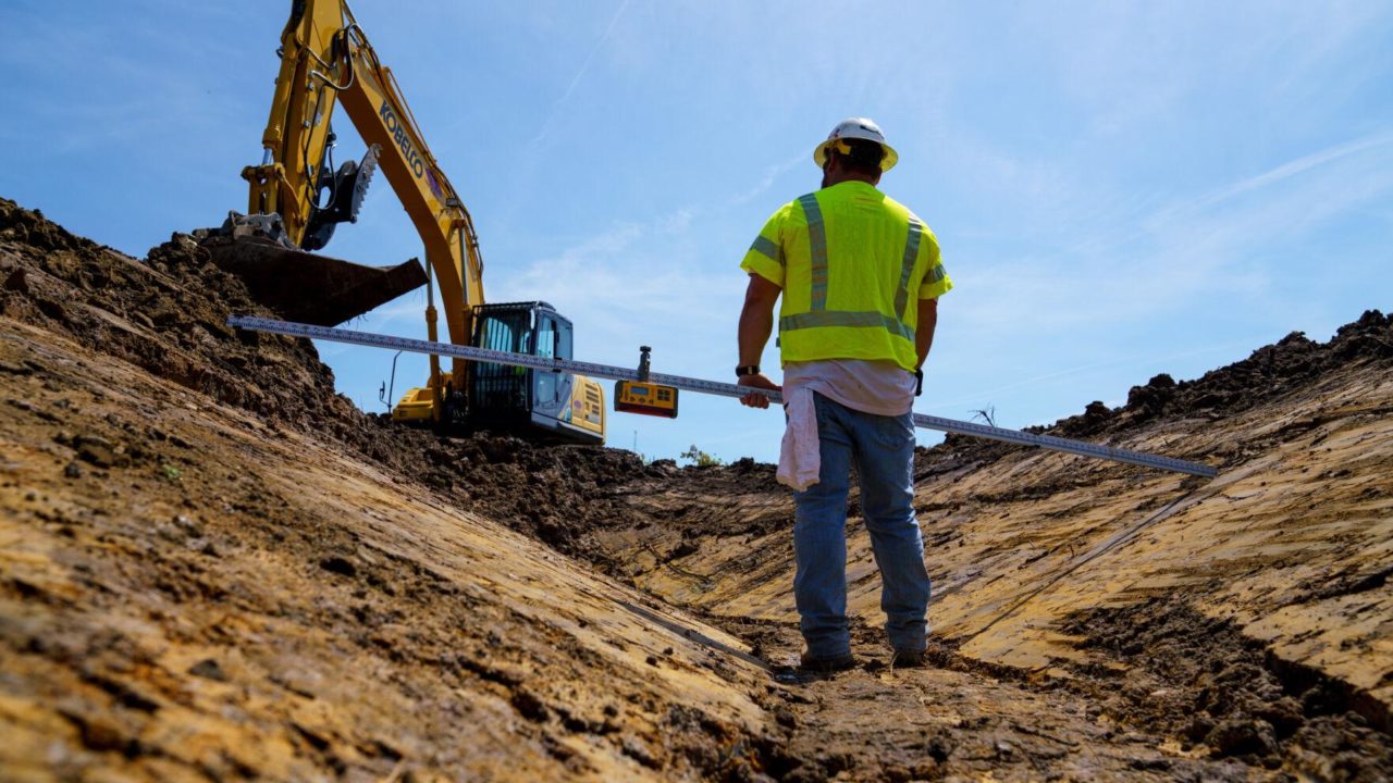 Man standing at dig site