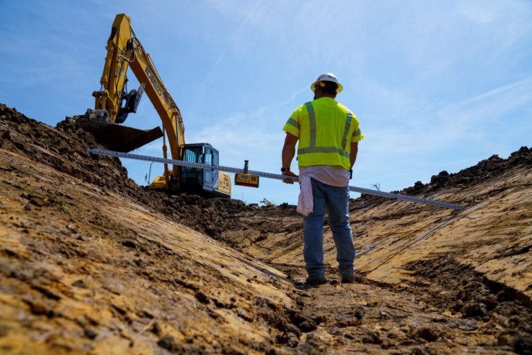 Man standing at dig site