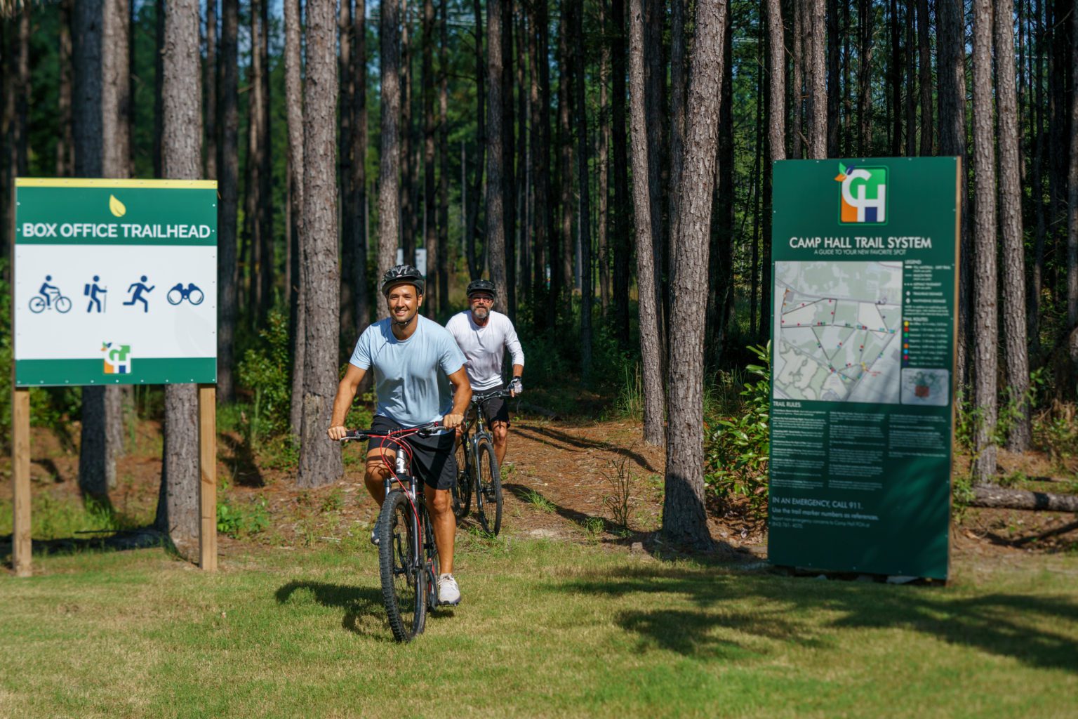 Two men biking on Camp Hall trails