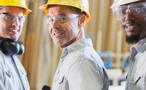Three workers wearing hard hats