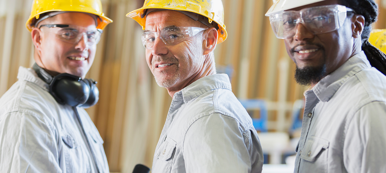 Three workers wearing hard hats